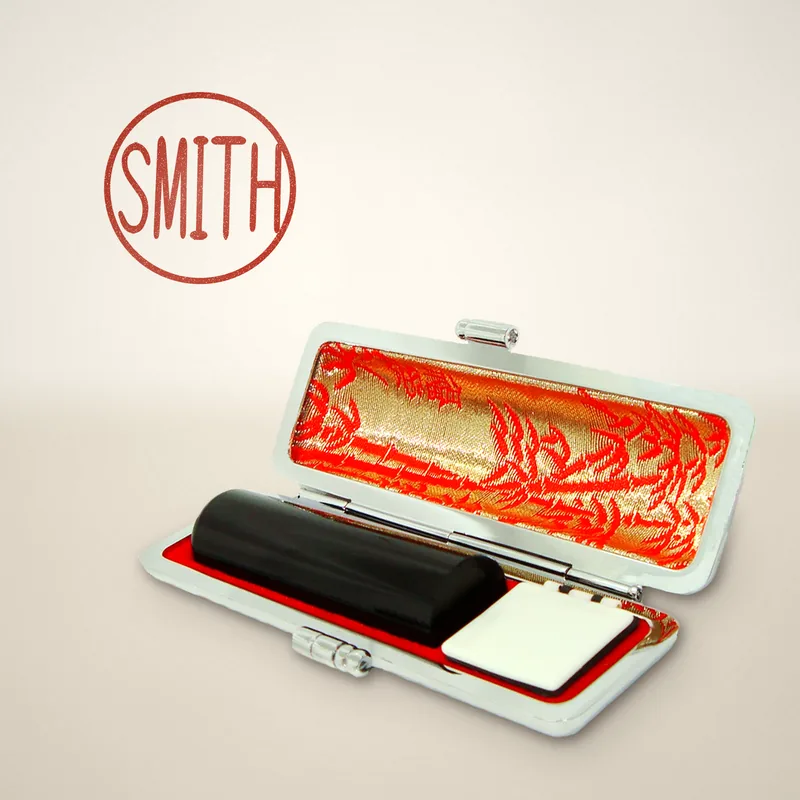 Registered seal in black buffalo horn inside its open case, with a red sample impression reading SMITH
