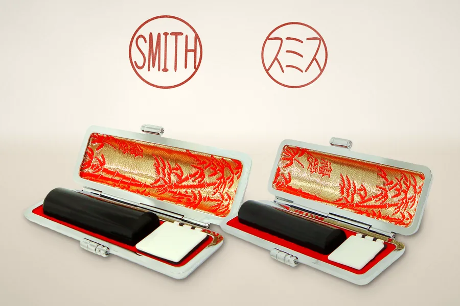 A registered seal and a bank seal, each in its own open leather case