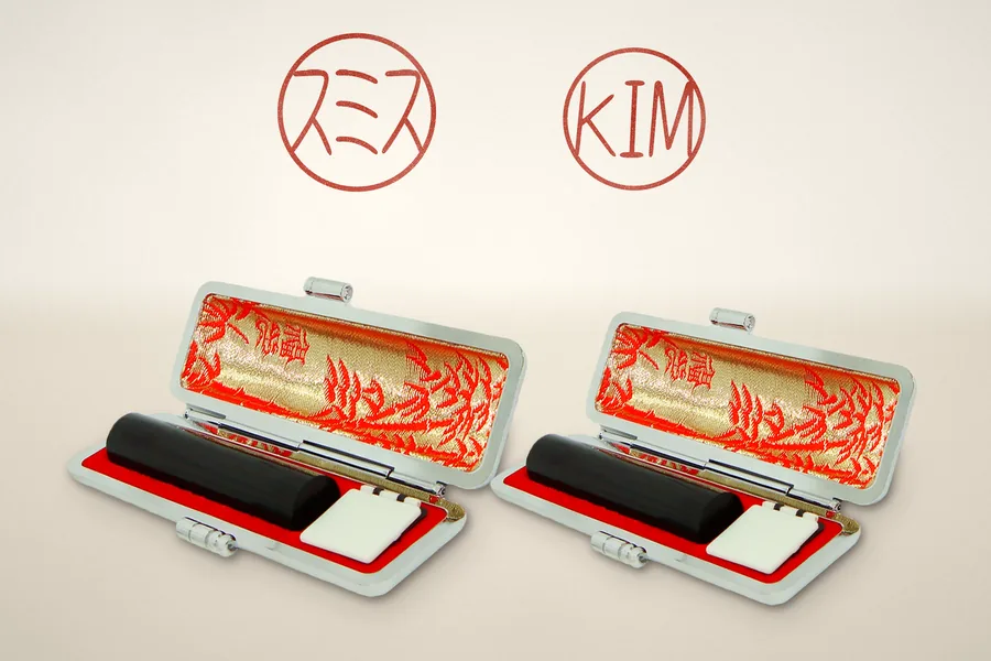 A bank seal and an everyday seal, each in its own open leather case
