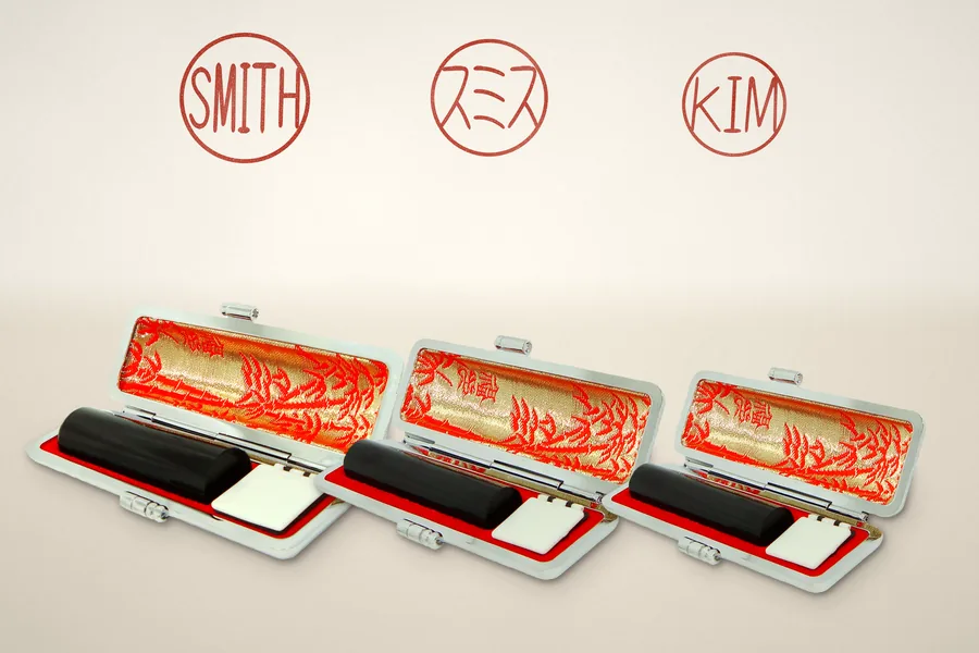 A registered seal, a bank seal and an everyday seal, each in its own open leather case